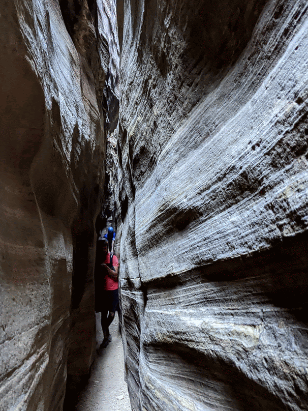 Jared squeezing through a tight canyon
