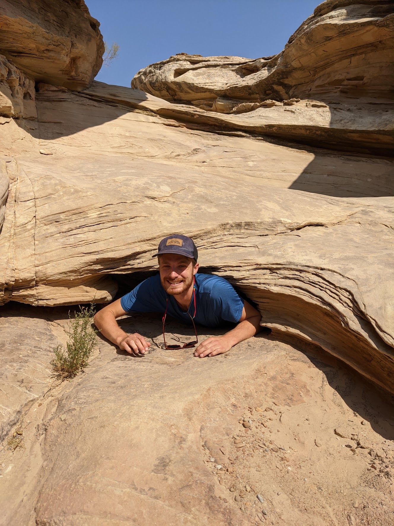 Me squeezing under a rock