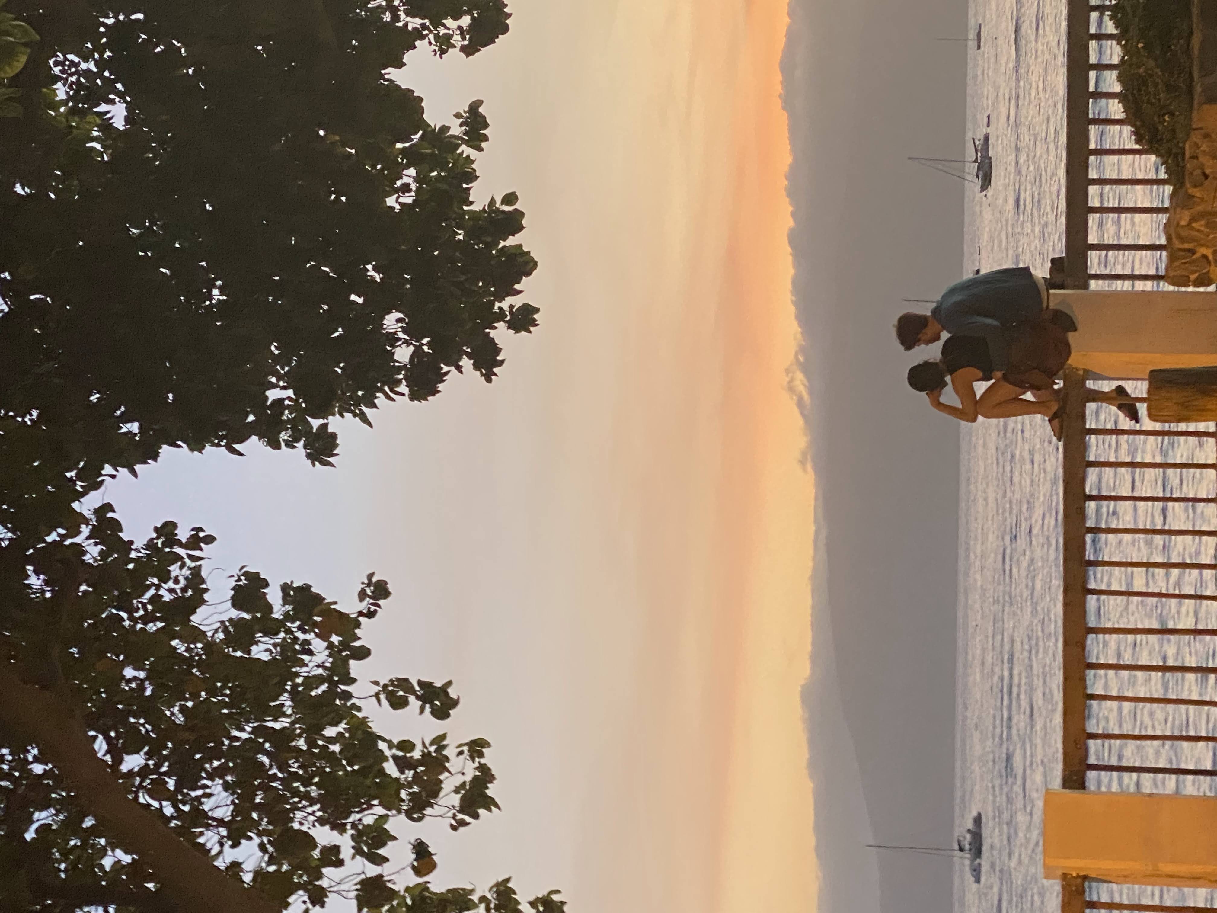 Mattie and me on a wall looking at the sunset in Lahaina